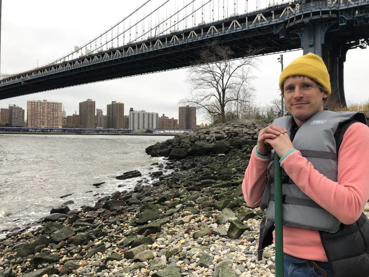 Jamie Burkart at the East River shoreline beneath the Manhattan Bridge.